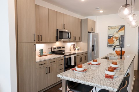 The Wren 1 bedroom model apartment home kitchen with stainless steel appliances located in Lawrenceville,GA